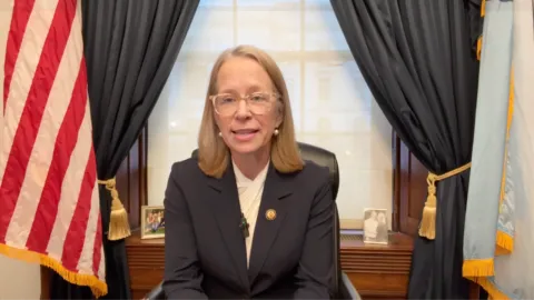 Rep. Kelly Morrison speaks from her desk